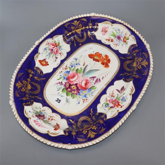 A Bloor Derby meat plate, painted with flowers within a gilt blue border length 45cm